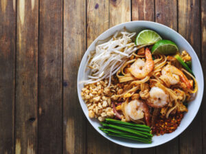 shrimp pad thai on plate flat lay composition 2023 11 27 04 49 54 utc